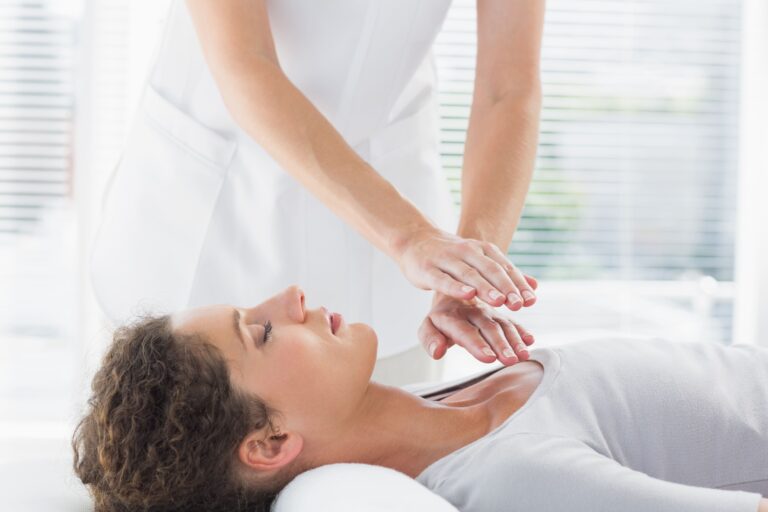 therapist-performing-reiki-woman
